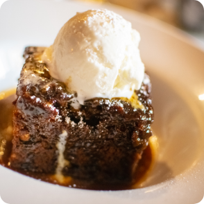 Summerlands | Mealtime image showing a sticky toffee pudding