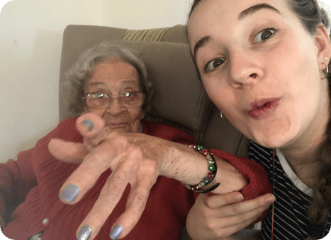 Summerlands | an image showing one of our residents and a member of our staff laughing and enjoying a conversation