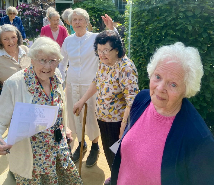 Summerlands | an image showing several of our residents outside gathering at the front of our home