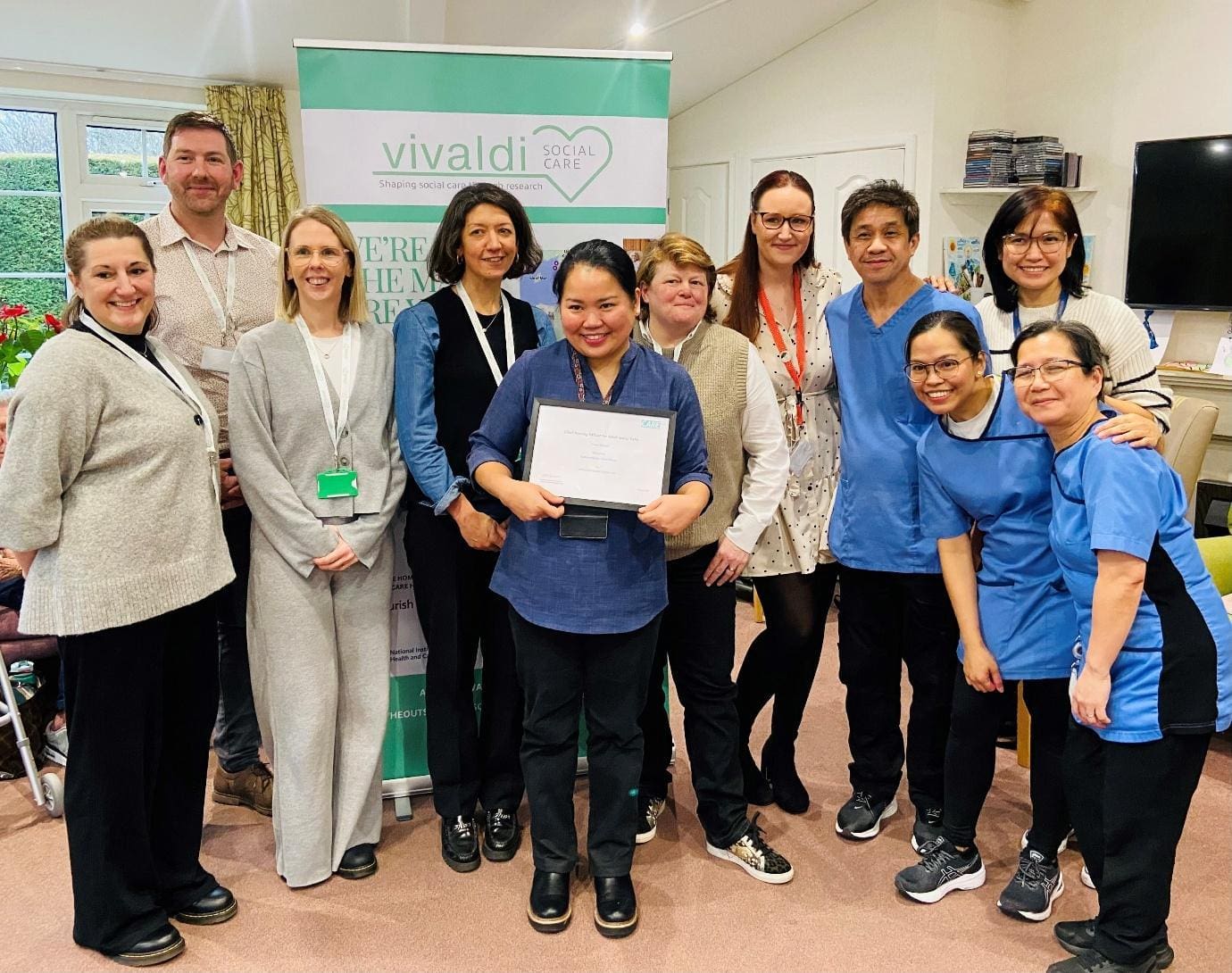 Summerlands | image showing staff holding a certificate in relation to the Vivaldi Care Project